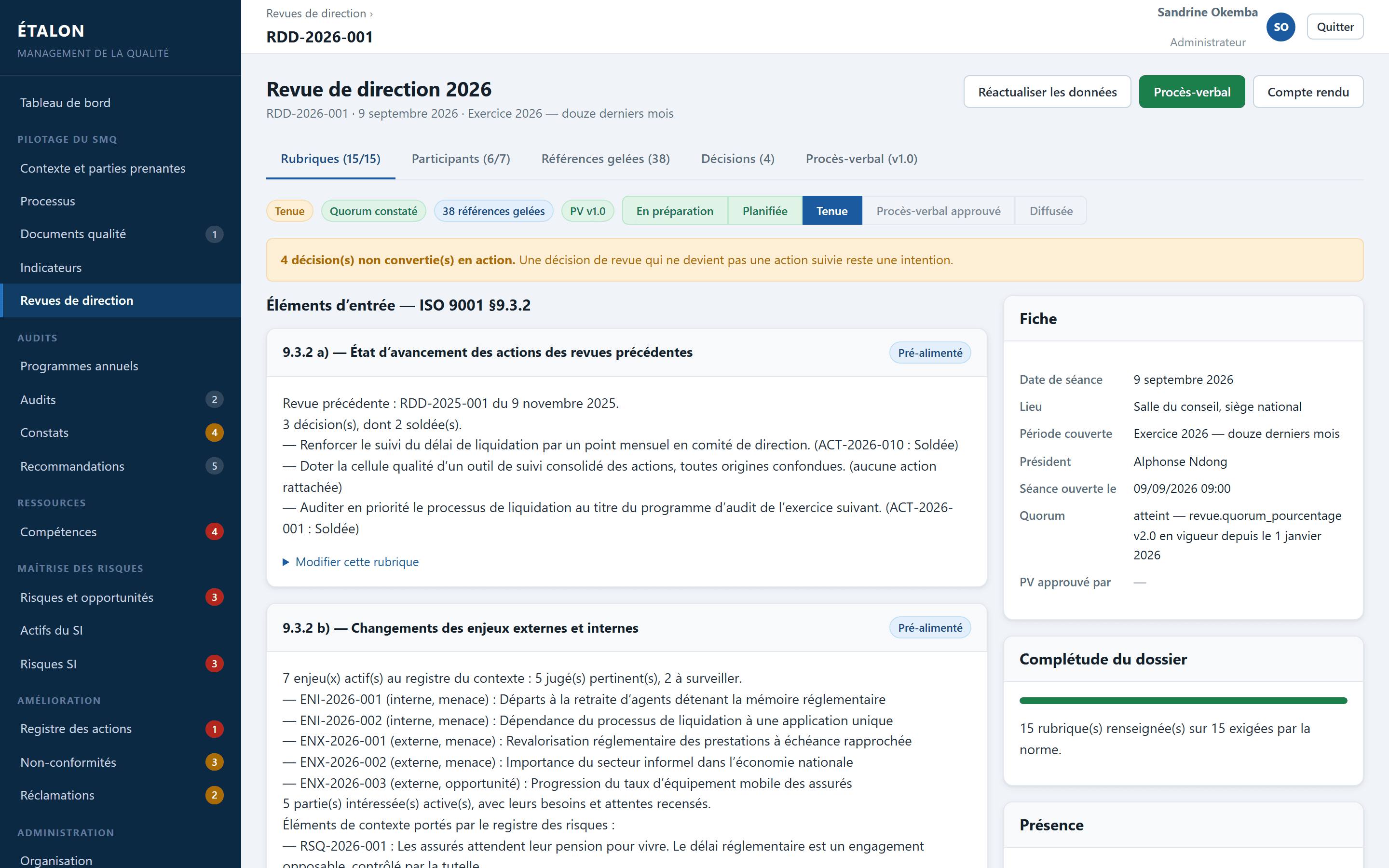 Fiche d'une revue de direction, avec ses quinze rubriques renseignées sur quinze, les éléments d'entrée de la clause 9.3.2 pré-alimentés, et une alerte signalant les décisions non converties en actions.
